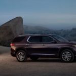 A burgundy 2020 Chevy Traverse is parked at a camp site at dusk.