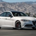 A white 2020 Alfa Romeo Giulia is shown parked on a racetrack.