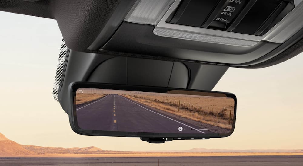 The black interior of a 2022 Ram 1500 shows the rear view mirror.