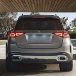 A popular pre-owned luxury SUV, a silver 2022 Mercedes-Benz GLE, is shown from the rear in a driveway.