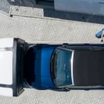 A car being repossessed is shown from a high angle.