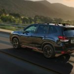 A black 2022 Subaru Forester is shown from the rear at an angle.