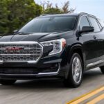 A black 2023 GMC Terrain Denali is shown driving after winning a 2023 GMC Terrain vs 2023 Nissan Rogue comparison.