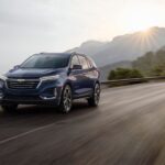 A blue 2024 Chevy Equinox Premier is shown from the front at an angle.