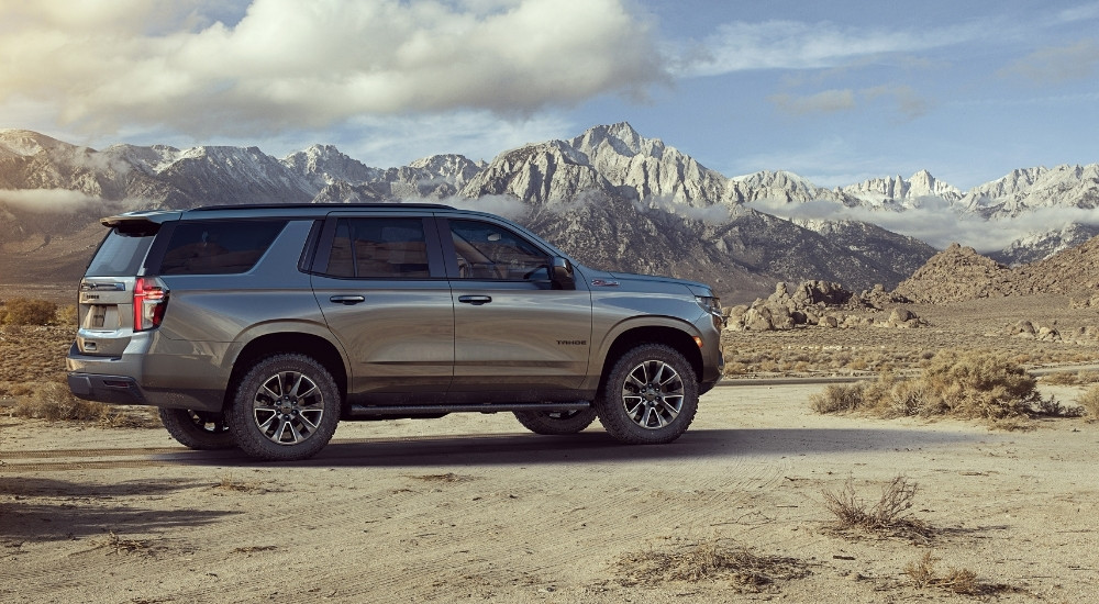 A grey 2022 Chevy Tahoe Z71 is shown off-road after leaving a Chevy dealer.