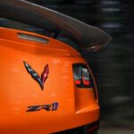 A close-up of the rear end of an orange 2019 Chevrolet Corvette ZR1 is shown.