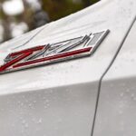A close-up of the Z71 badge is shown on a white 2023 Chevy Tahoe Z71.