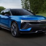 A blue 2024 Chevy Blazer is shown driving from a Chevy dealer.