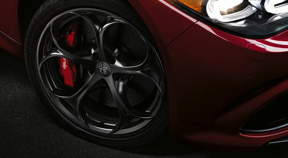 Close-up of the wheel on a red 2024 Alfa Romeo Giulia Quadrifoglio.