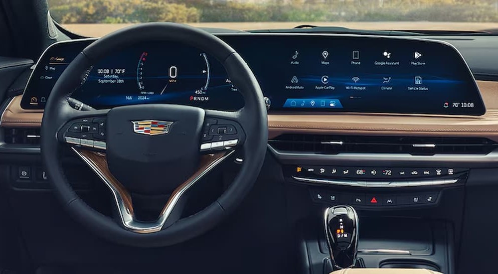 The black and tan interior and dash is shown in a 2024 Cadillac XT4.