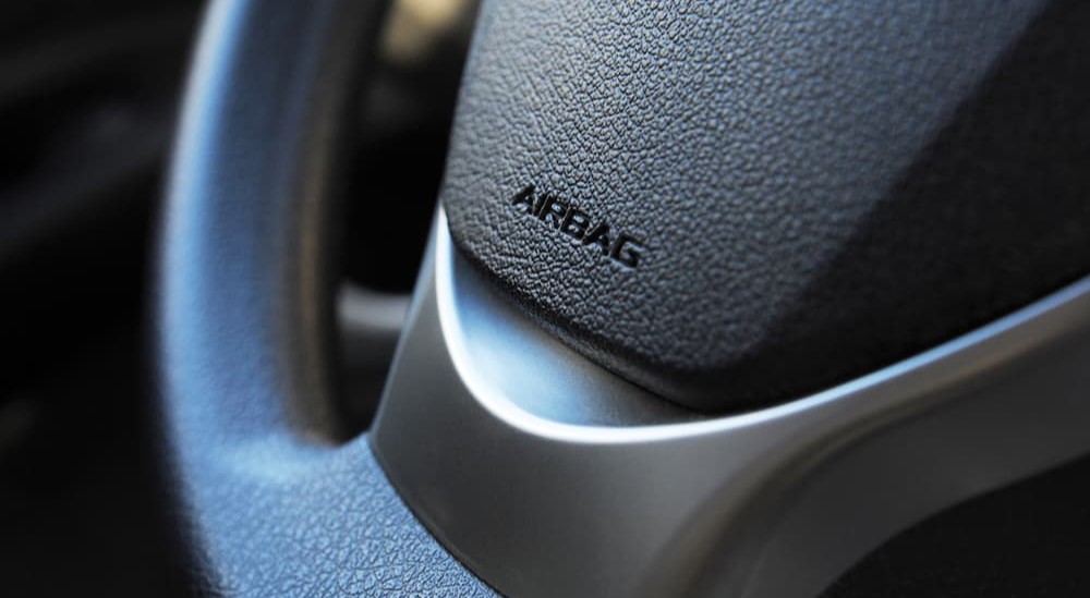 Airbag is shown stamped on a steering wheel.