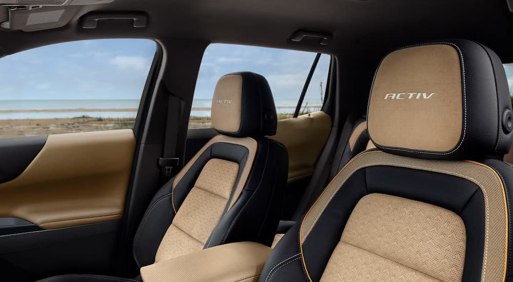 The black and brown front seats in a 2024 Chevy Equinox ACTIV at a Chevy dealer.