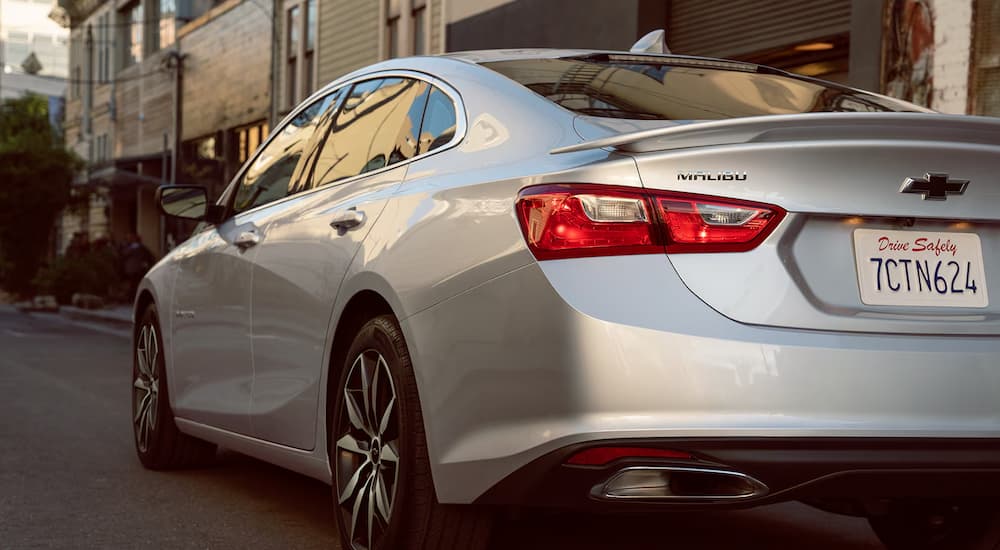 A rear view of a silver 2024 Chevy Malibu RS.
