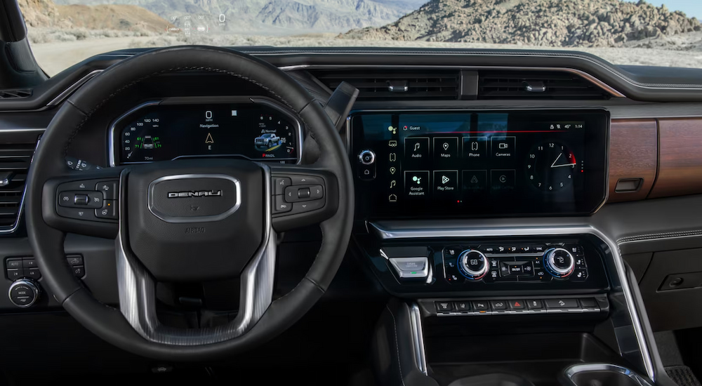 The steering wheel and infotainment screen in a 2024 GMC Sierra 2500 HD Denali.