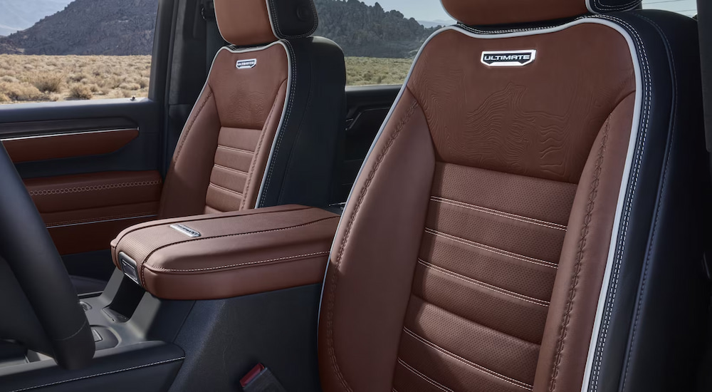 The brown leather front seats in a 2024 GMC Sierra 2500 HD Denali Ultimate for sale.