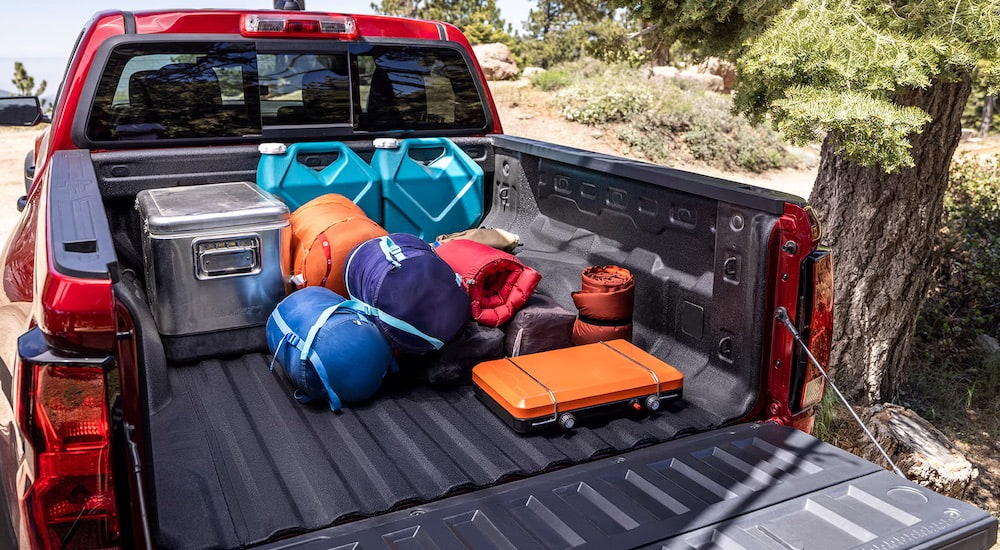 The black bed of a red 2024 Chevy Colorado is shown.