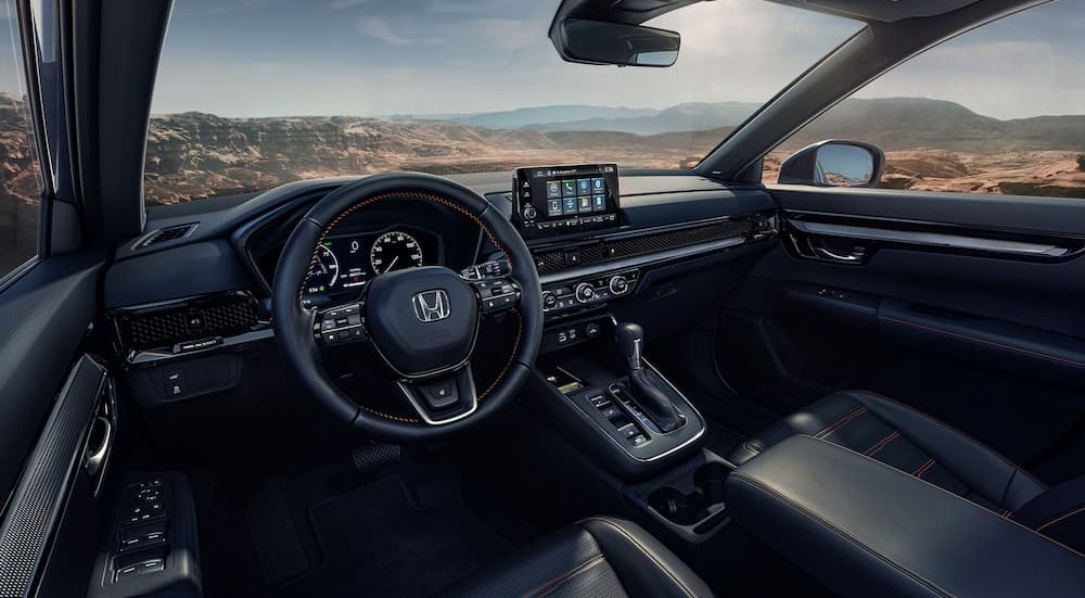 The black interior and dash in a 2024 Honda CR-V Hybrid is shown.