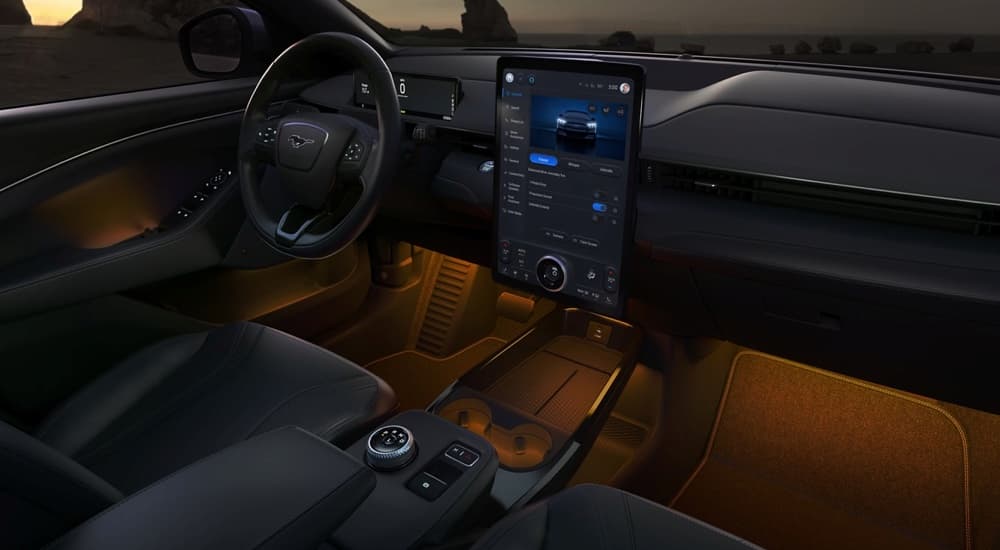 Orange ambient lighting in the cabin of a 2024 Ford Mustang Mach-E at a Ford dealer.