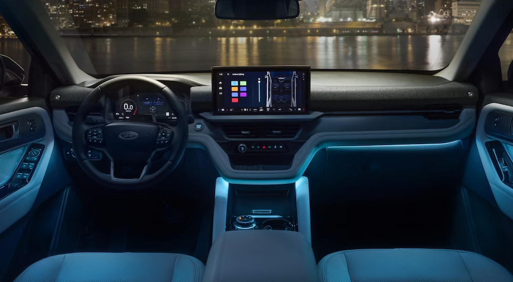 Blue ambient lighting in the cabin of a 2025 Ford Explorer Platinum at a Ford dealer.