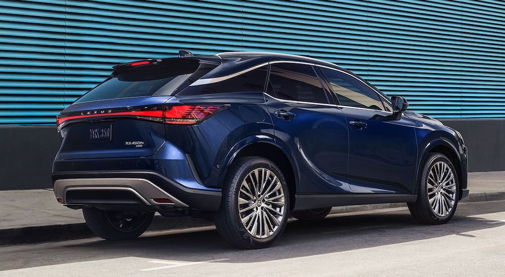 A blue 2024 Lexus RX is shown from the rear at an angle.