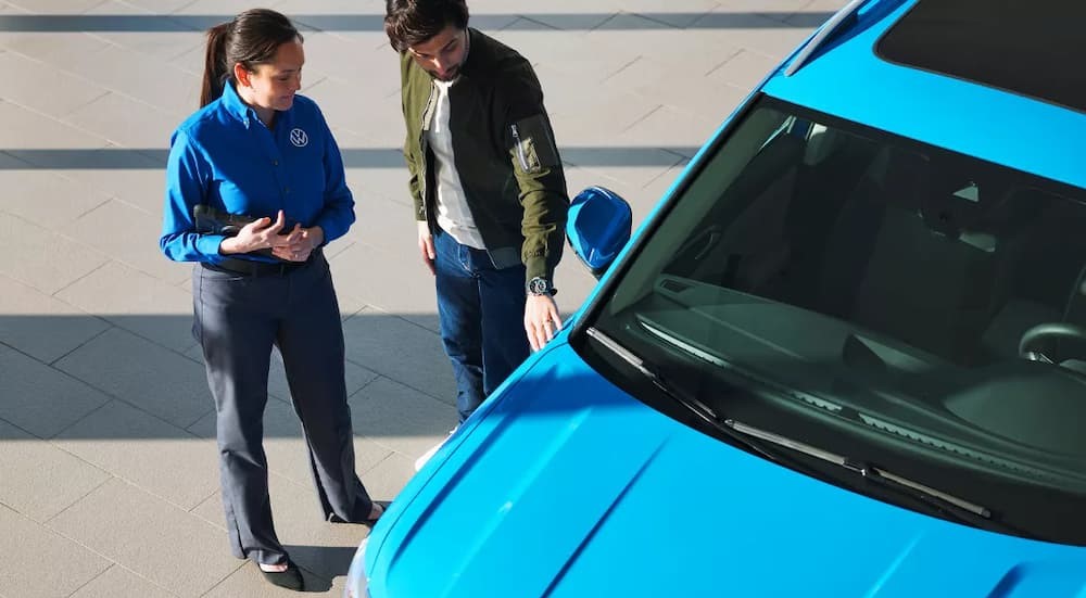 A Volkswagen employee is shown talking to a customer.