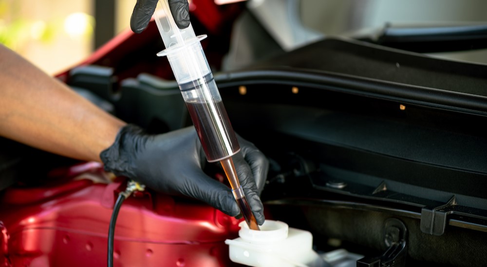 A mechanic is shown exchanging brake fluid during a brake service.