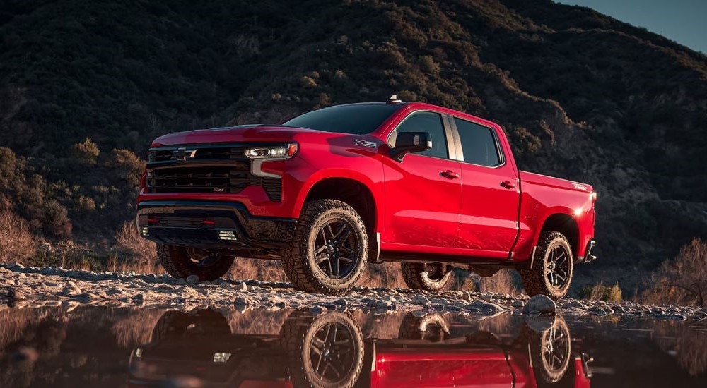 a red 2024 Chevy Silverado Z71 Trail Boss is shown from the front at an angle.