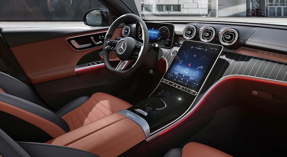 The red interior of a 2024 Mercedes-Benz C Class is shown from the passenger side.