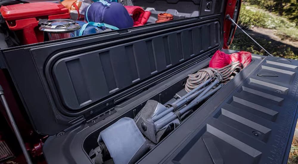 The StowFlex tailgate is shown on a red 2024 Chevy Colorado.