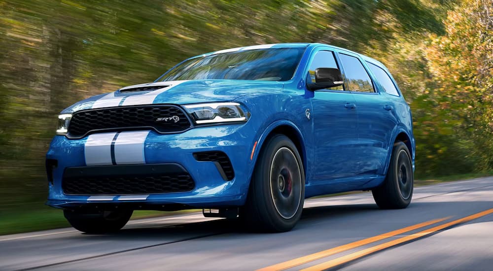 A blue 2024 Dodge Durango SRT driving.