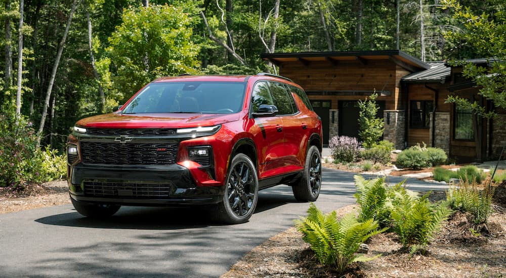 A red 2024 Chevy Traverse RS is shown from the front at an angle.