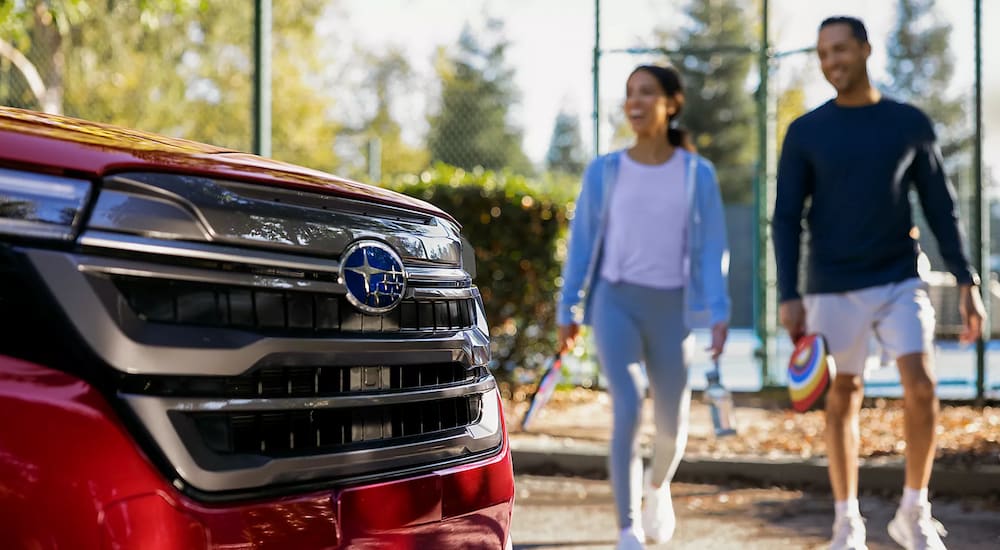 A close-up on the grille of a red 2025 Subaru Forester.