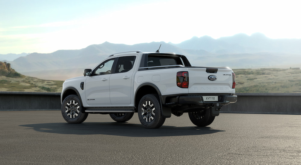 A rear view of a parked white 2025 Ford Ranger PHEV.