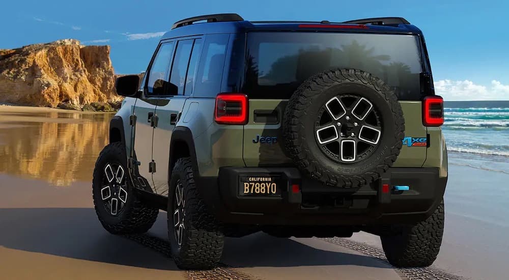 A green 2024 Jeep Recon is shown from the rear at an angle.