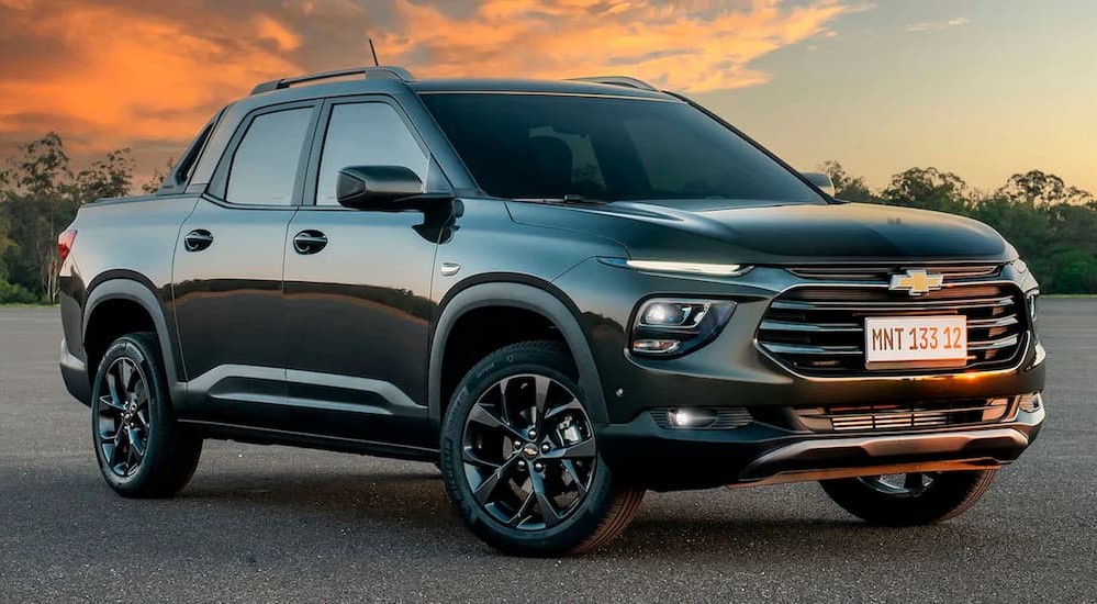 A gray 2023 Chevy Montana is shown parked off-road.