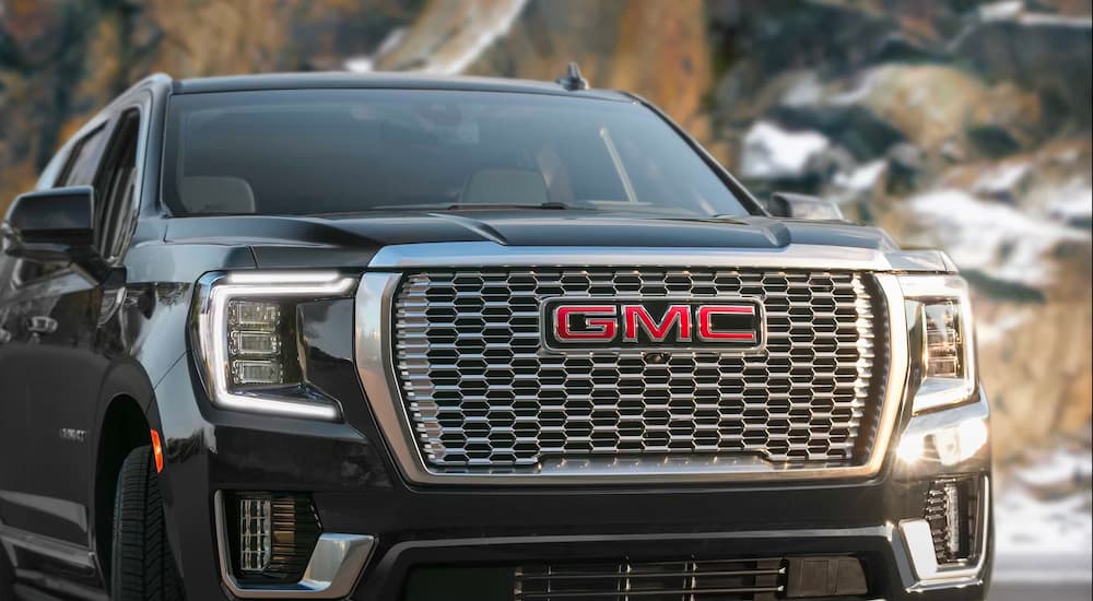 A close-up on the grille of a black 2023 GMC Yukon Denali.