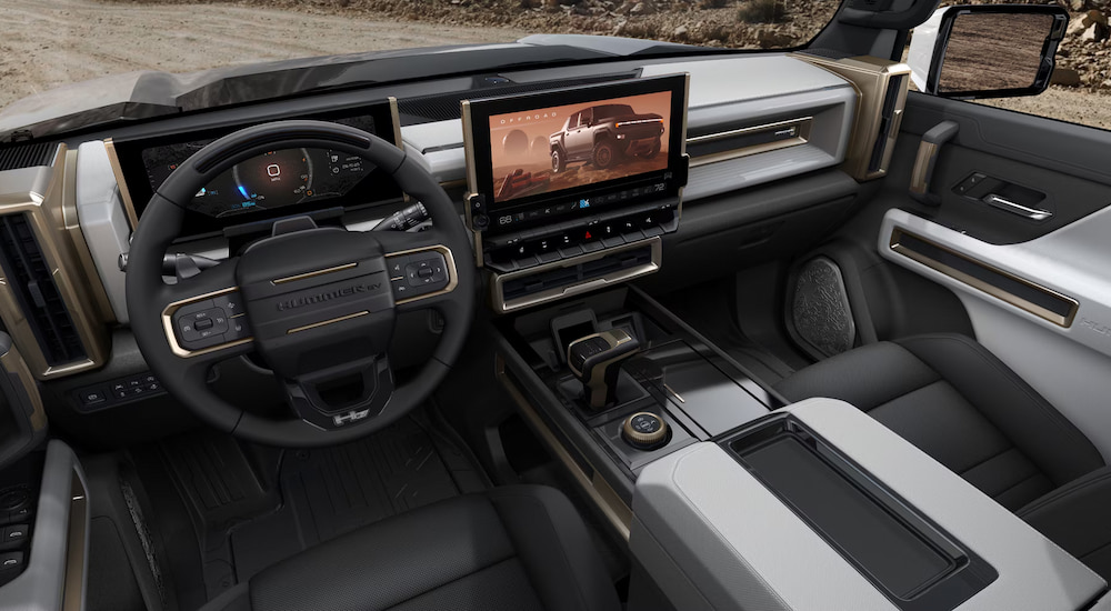 The front seats and infotainment screen in a 2024 GMC Hummer EV Pickup.