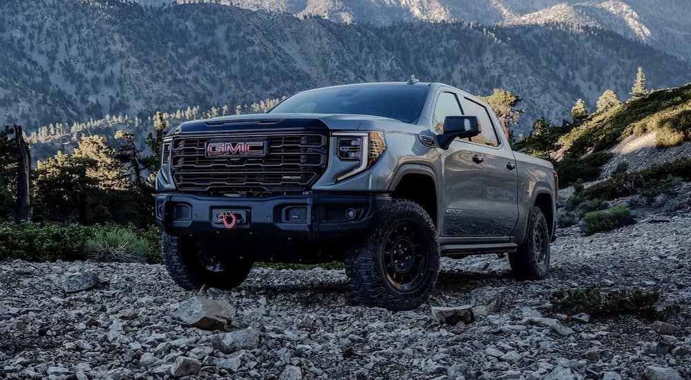 A grey 2024 GMC Sierra 1500 parked off-road.