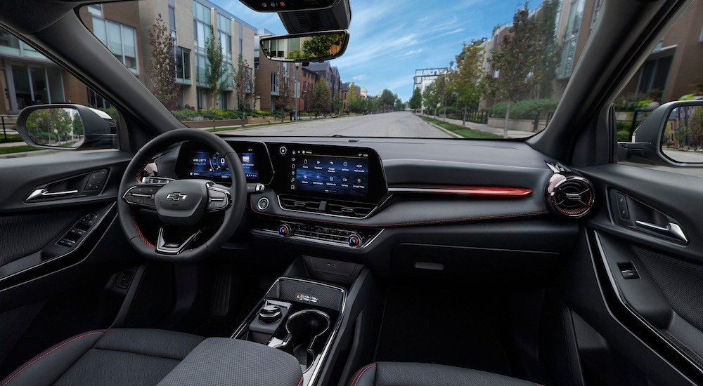 The black interior of a 2025 Chevy Equinox RS is shown from the passenger seat.