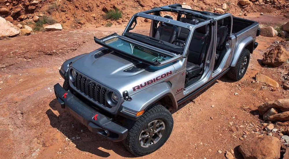 A silver 2024 Jeep Gladiator Rubicon is shown from the front at an angle.