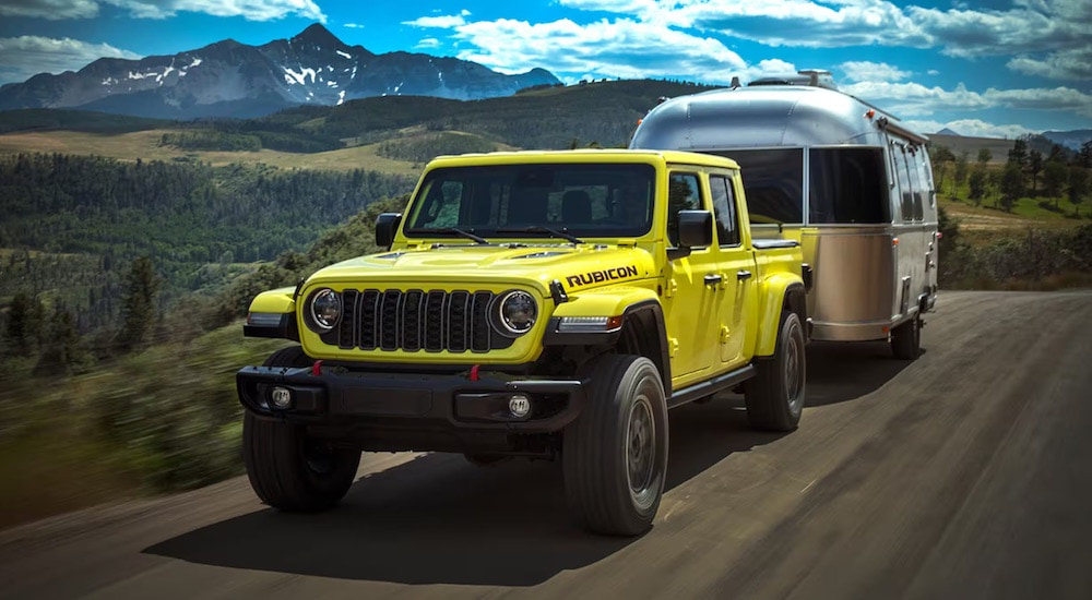 A green 2024 Jeep Gladiator Mojave is shown from the front at an angle.