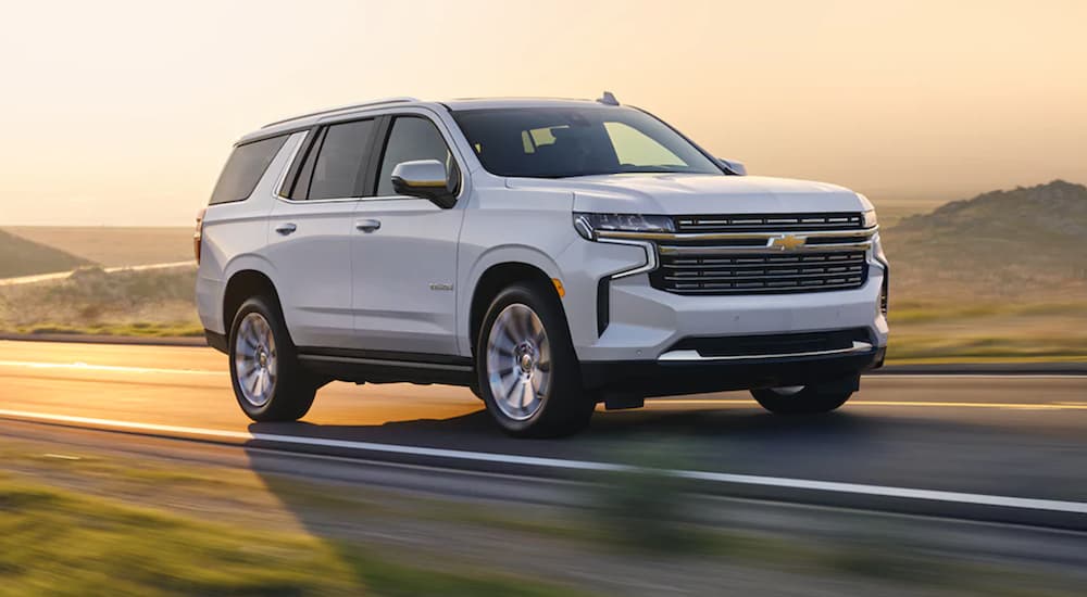 A white 2021 Chevy Tahoe is shown from the front at an angle after leaving a used Chevy dealer.