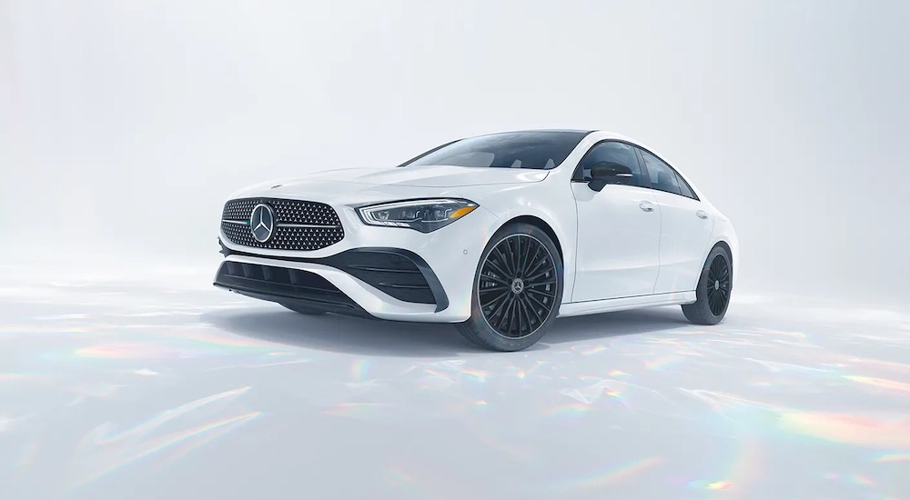 A white 2024 Mercedes-Benz CLA is shown from the front at an angle after leaving a Mercedes-Benz dealer near me.