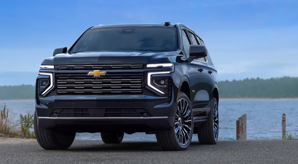 A black 2024 Chevy Tahoe High Country is shown from the front at an angle.