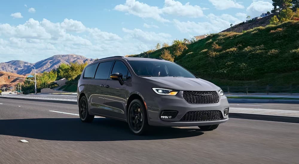 A grey 2024 Chrysler Pacifica is shown from the front at an angle.