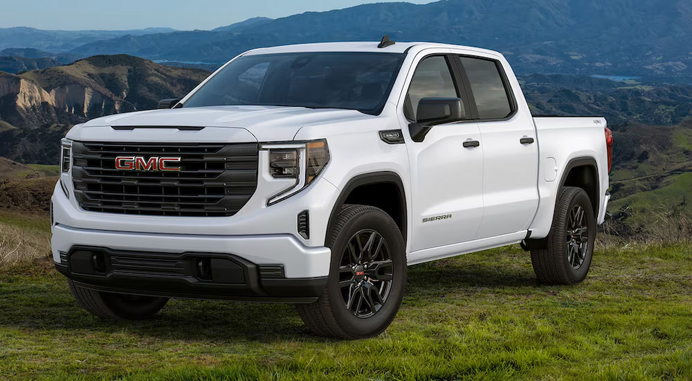 A white 2024 GMC Sierra 1500 Pro parked off-road and angled left.