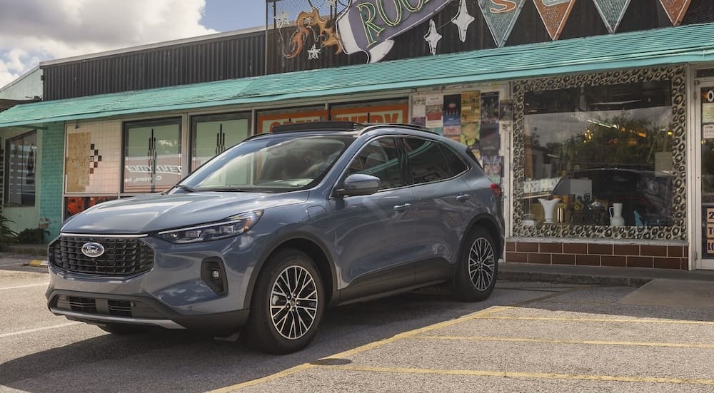 A gray 2025 Ford Escape PHEV is shown parked near a store.