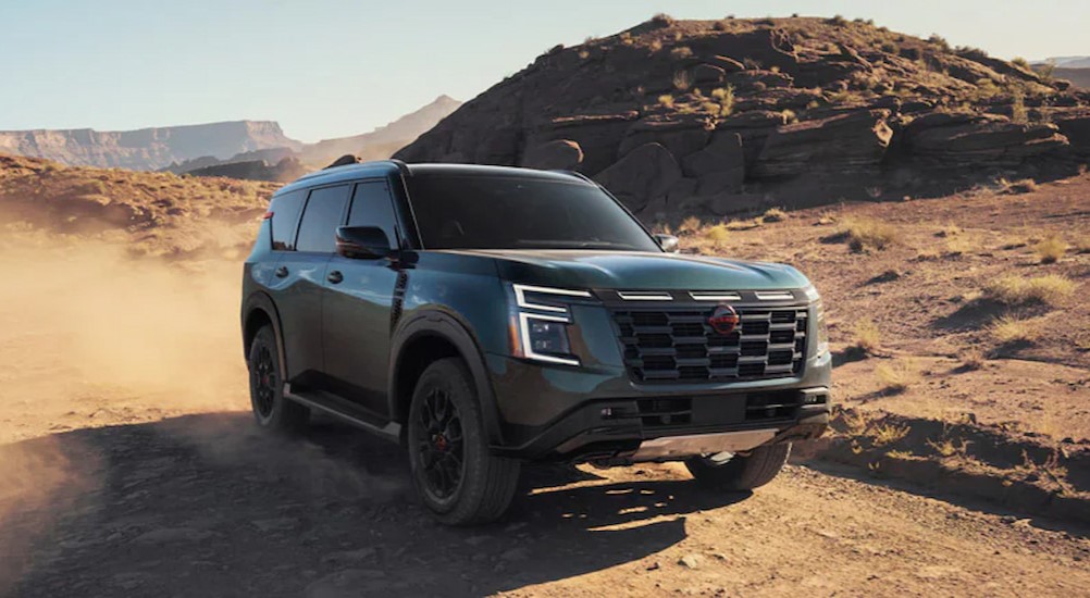 A green 2025 Nissan Armada PRO-4X is shown driving on a dirt path.