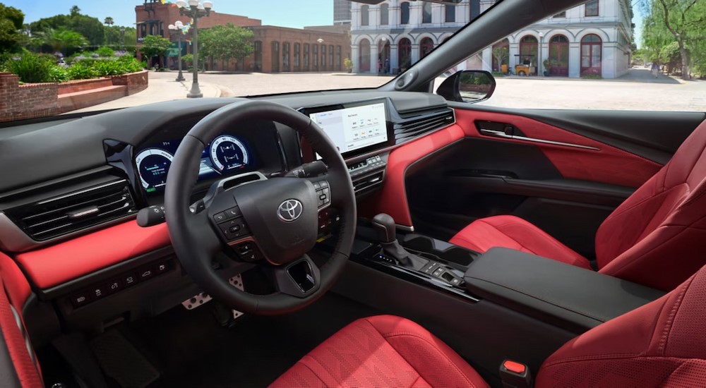 The black and red interior and dash is shown in a 2025 Toyota Camry.