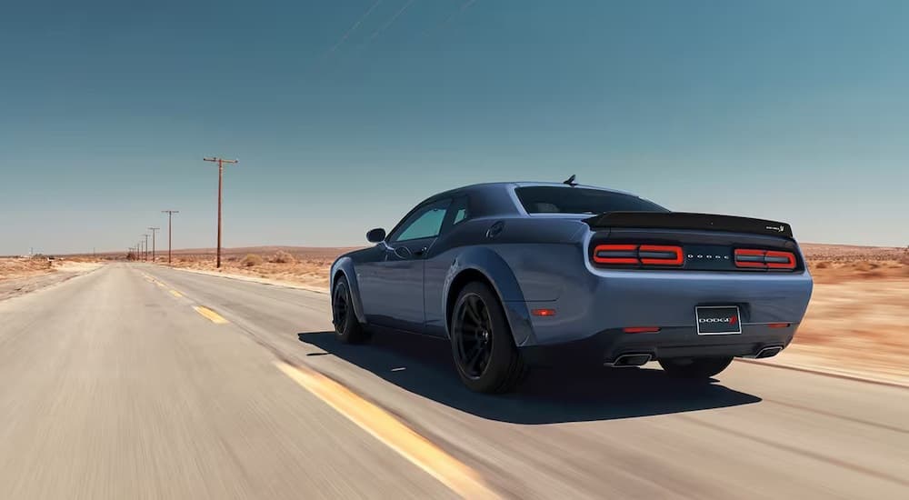 A blue 2023 Dodge Challenger RT is shown from the rear at an angle.